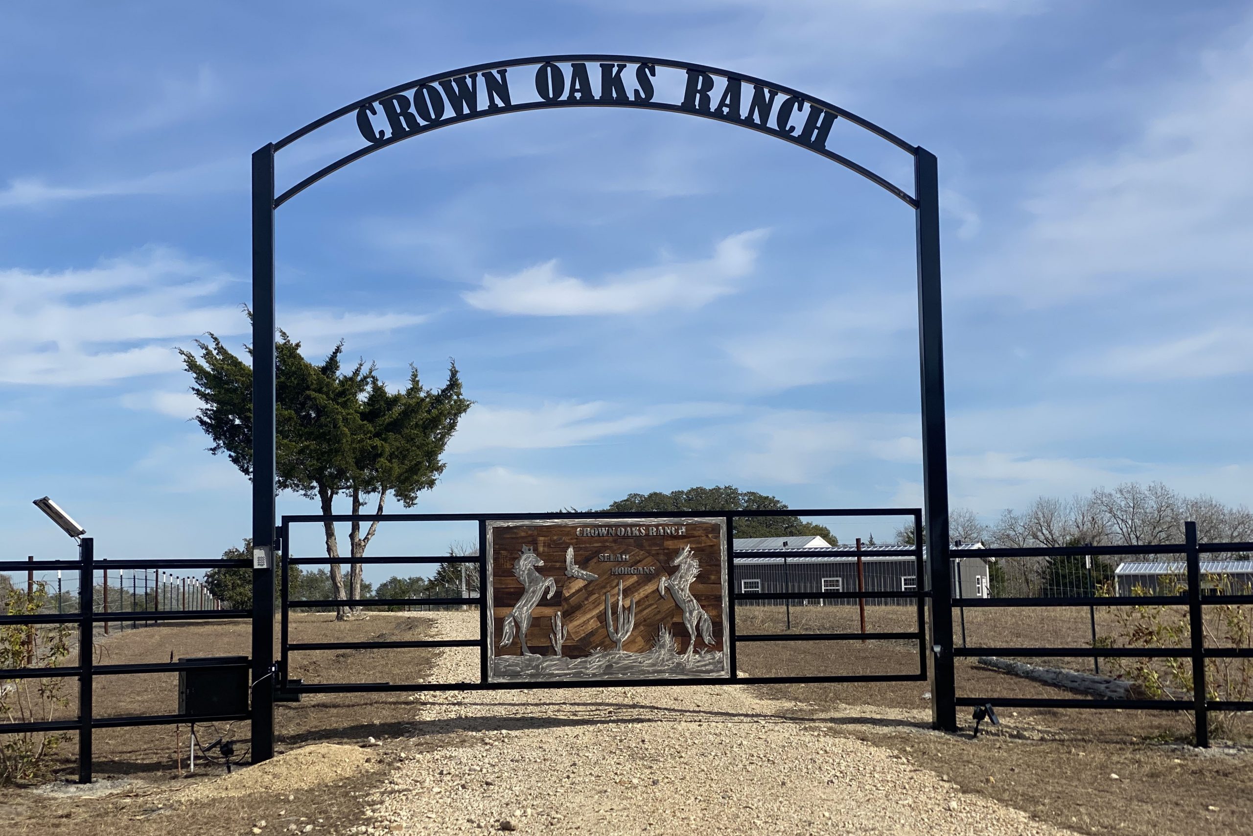 wood artwork panel for fence gate with overhang ranch name