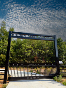 Custom gate with bible verse John 4:14 and custom overhead