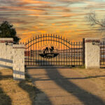 Custom gate with the center having a "painted horse" and arch on top of the gate.