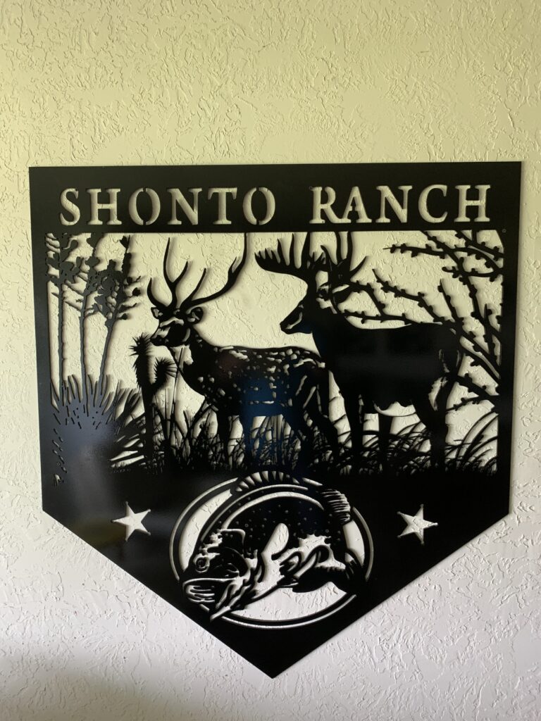 two deer with a bass fish cut out of metal